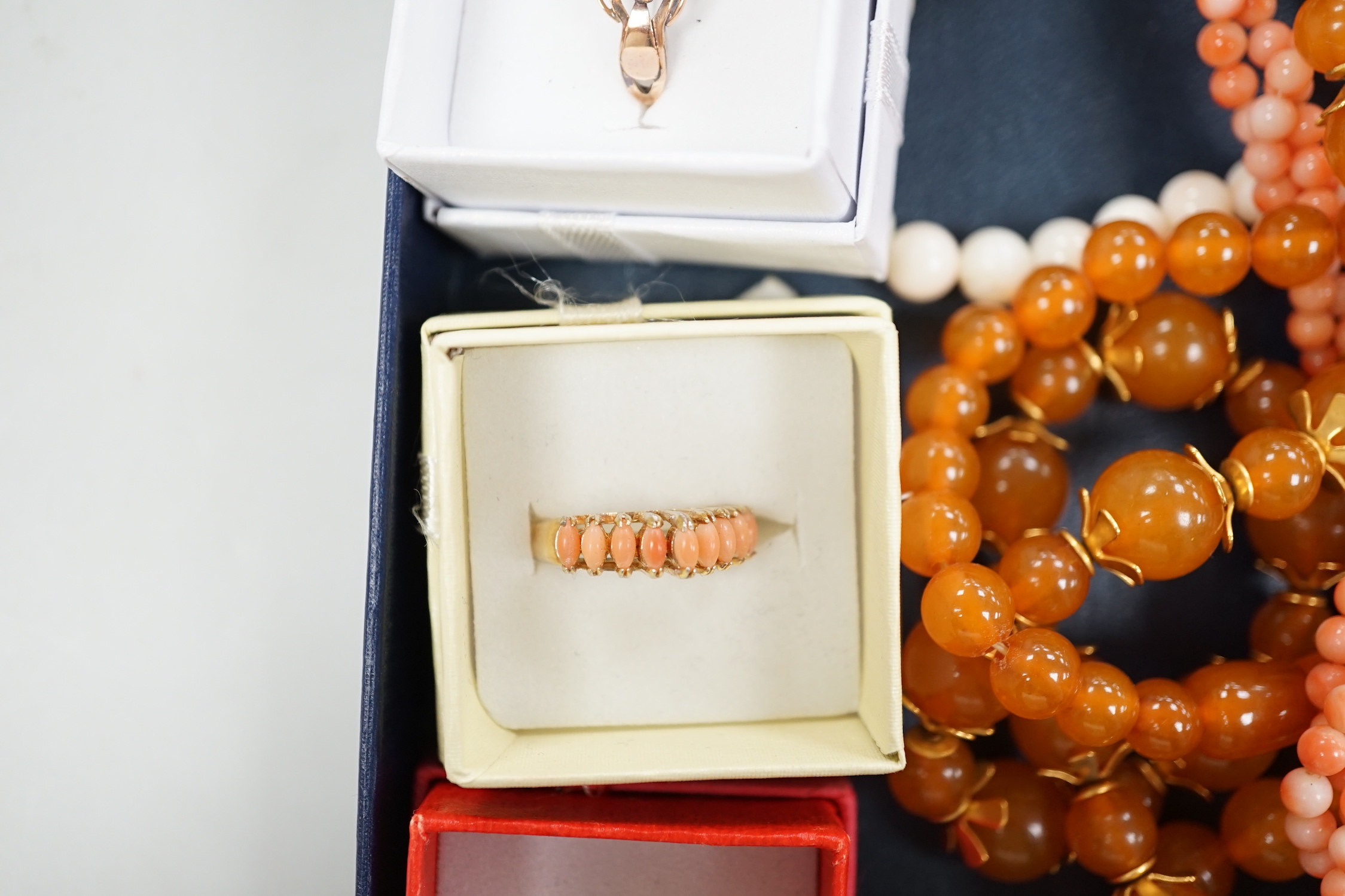 A 9ct and opal doublet ring, two other 9ct and gem set rings, an Edwardian yellow metal and swivelling carnelian ring and six assorted necklaces.